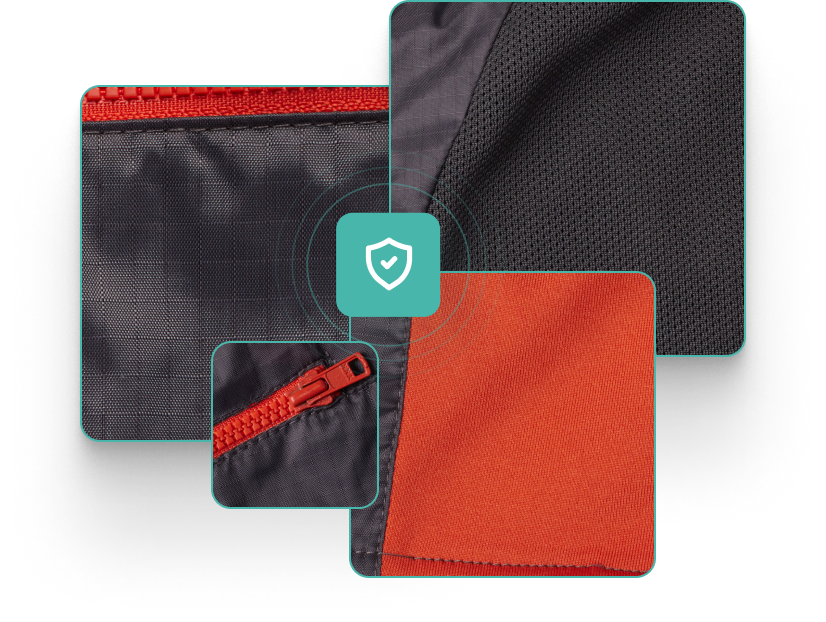 Perci Vest close up showing charcoal colored ripstop nylon, gray polyester mesh, orange knit side panel, and orange zippers